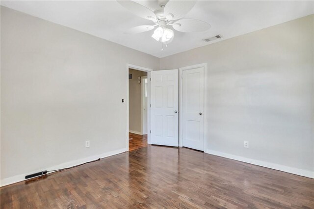 unfurnished bedroom with dark hardwood / wood-style flooring and ceiling fan