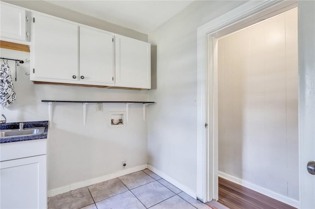 clothes washing area with sink, cabinets, electric dryer hookup, hookup for a washing machine, and light tile patterned flooring