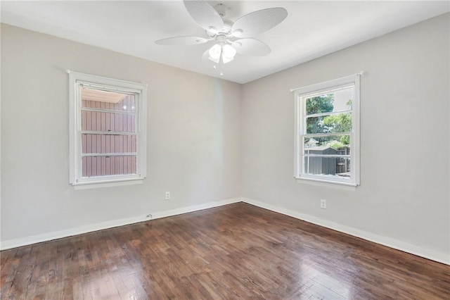 unfurnished room with ceiling fan and dark wood-type flooring