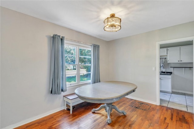 dining space featuring hardwood / wood-style floors and a notable chandelier