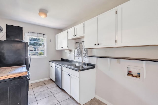 kitchen with dishwasher, white cabinets, black refrigerator, sink, and light tile patterned floors