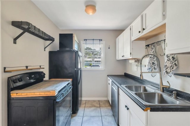 kitchen with sink, white cabinets, black appliances, and light tile patterned floors