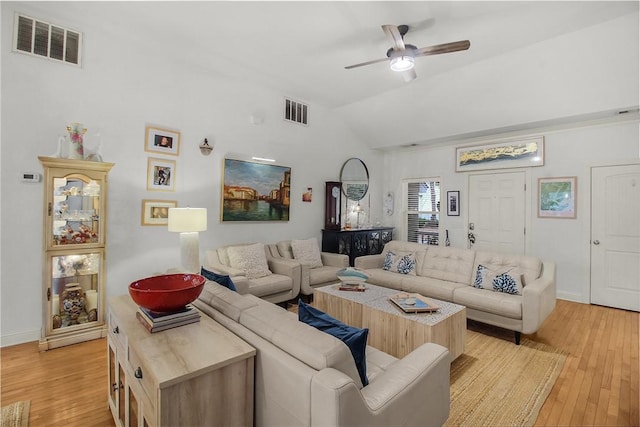 living room featuring ceiling fan, lofted ceiling, and light hardwood / wood-style floors