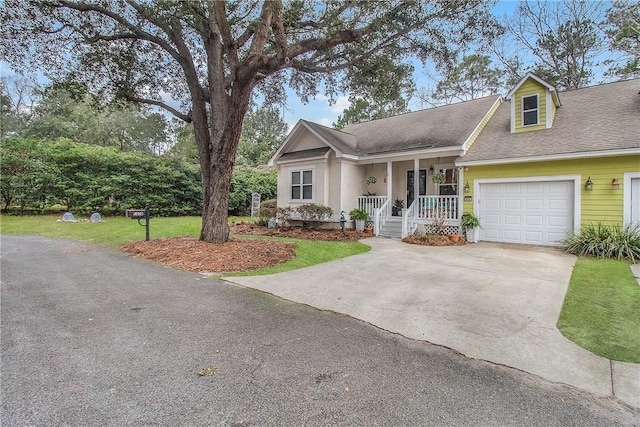 view of front of home featuring a garage, covered porch, and a front yard