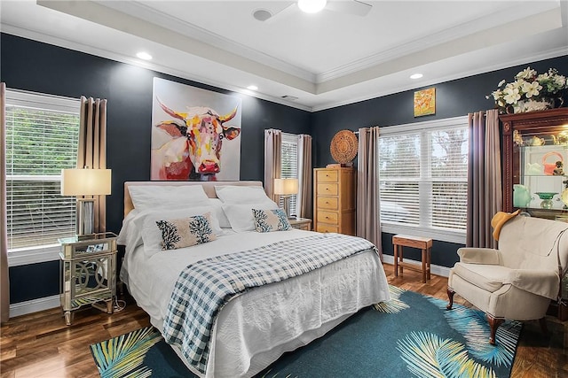 bedroom featuring a raised ceiling, wood-type flooring, ceiling fan, and crown molding