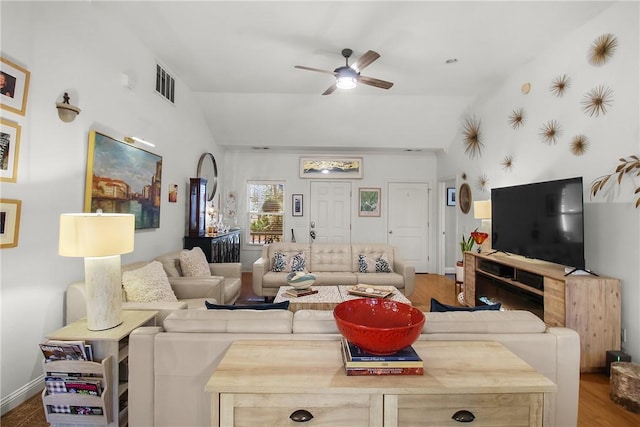 living room with hardwood / wood-style flooring, lofted ceiling, and ceiling fan