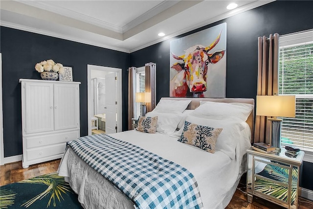 bedroom featuring ornamental molding, dark hardwood / wood-style floors, and ensuite bathroom