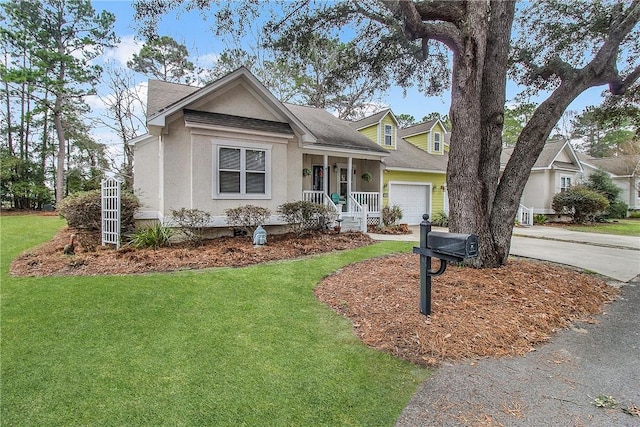 view of front of property featuring a porch, a garage, and a front yard