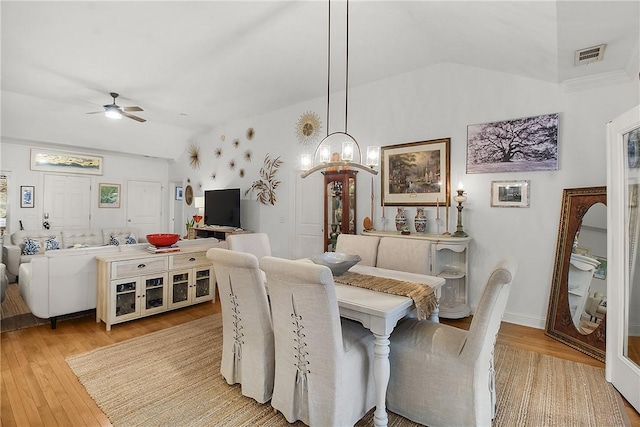 dining room with vaulted ceiling, light hardwood / wood-style floors, and ceiling fan