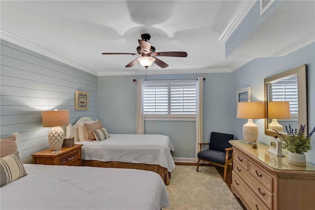 bedroom featuring ceiling fan, ornamental molding, wooden walls, and multiple windows