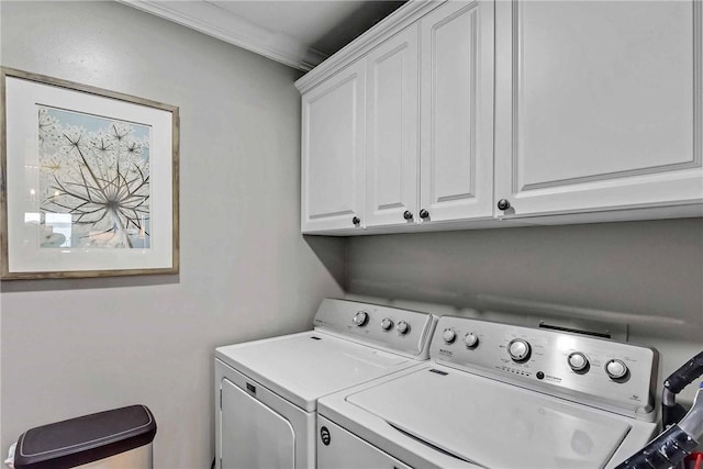 laundry room featuring cabinets, crown molding, and washer and dryer