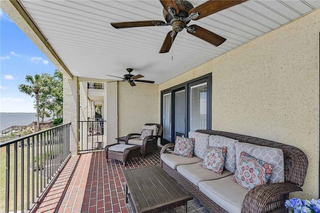 view of patio with a balcony and a water view