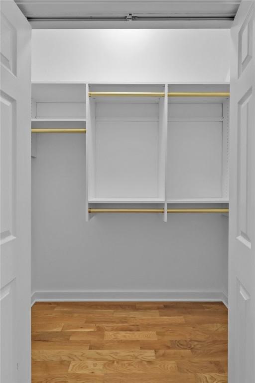 spacious closet featuring hardwood / wood-style floors