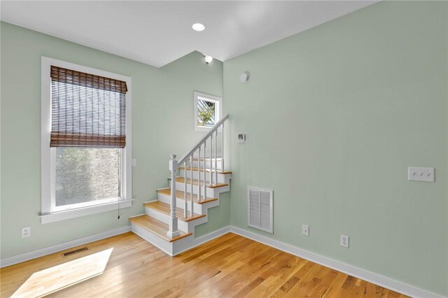 stairs featuring wood-type flooring