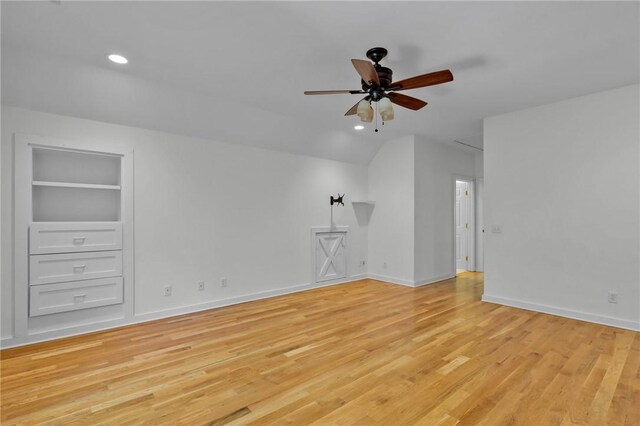 interior space featuring built in shelves, light hardwood / wood-style flooring, and ceiling fan