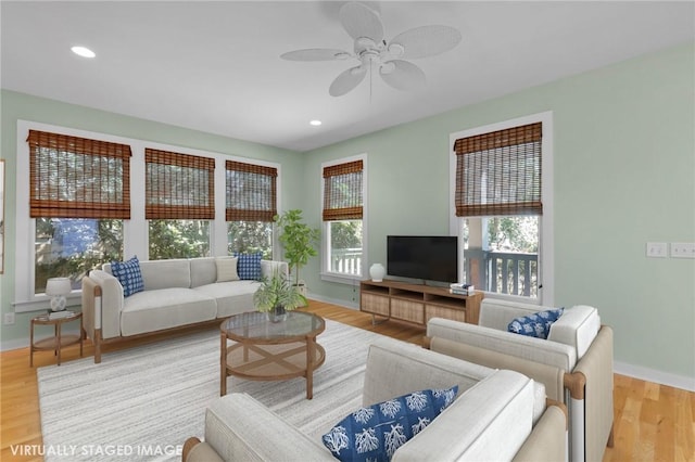 living room featuring ceiling fan and light wood-type flooring