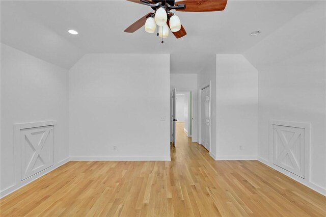 additional living space with ceiling fan, light hardwood / wood-style flooring, and vaulted ceiling