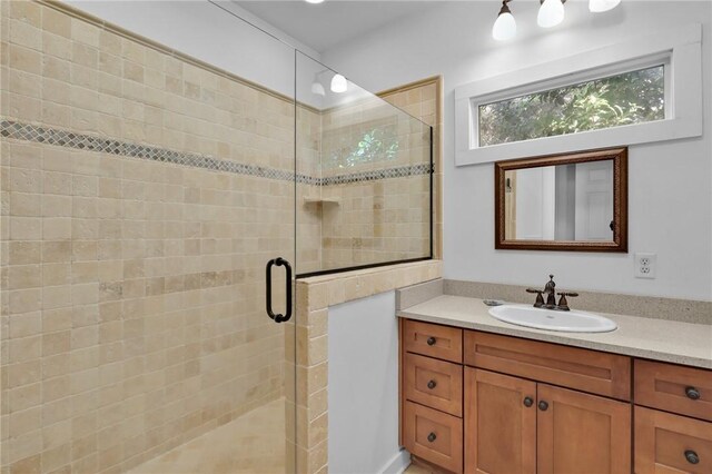 bathroom featuring vanity and an enclosed shower