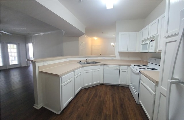 1704 Frederica Rd Unit 422, Saint Simons Island, GA 31522 - kitchen featuring white appliances, a sink, a peninsula, dark wood-type flooring, and white cabinets