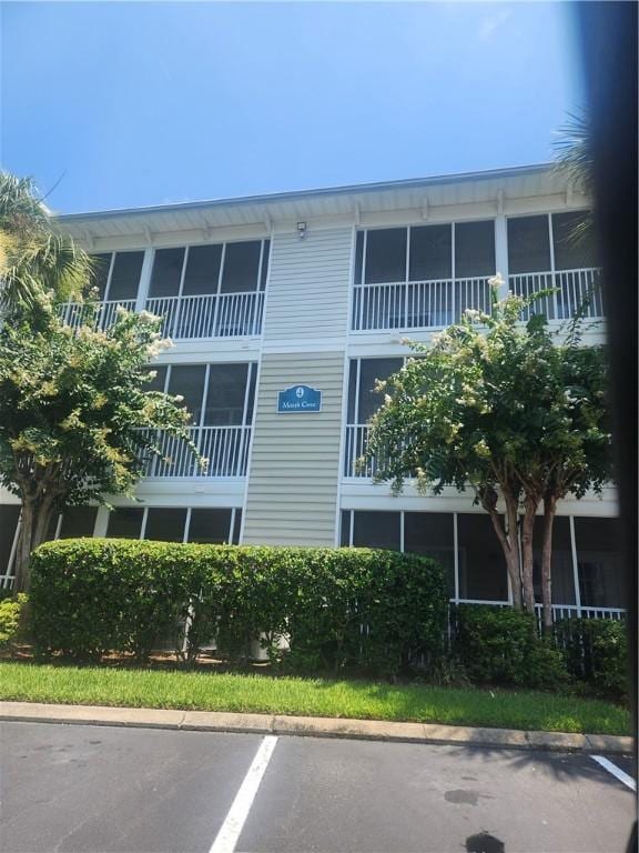 1704 Frederica Rd Unit 422, Saint Simons Island, GA 31522 - view of building exterior featuring uncovered parking