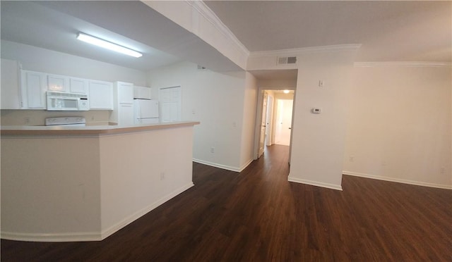 1704 Frederica Rd Unit 422, Saint Simons Island, GA 31522 - kitchen with white appliances, dark wood finished floors, white cabinets, baseboards, and crown molding