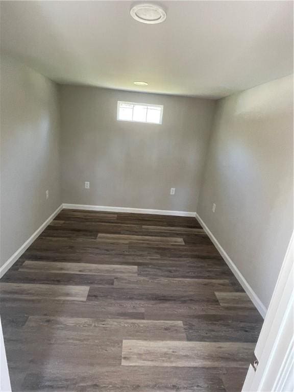 below grade area with dark wood finished floors and baseboards