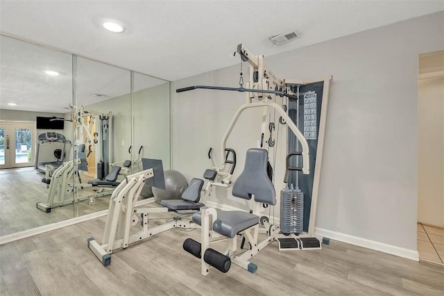 interior space with hardwood / wood-style floors and french doors