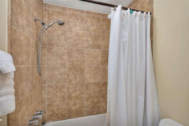 bathroom with shower / bath combo with shower curtain