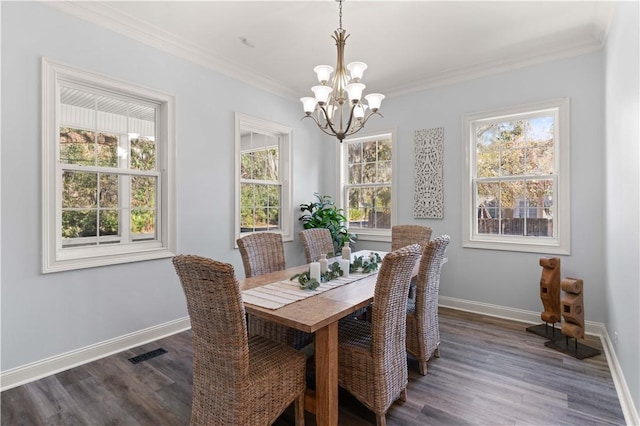 dining area with ornamental molding, dark hardwood / wood-style floors, and a notable chandelier