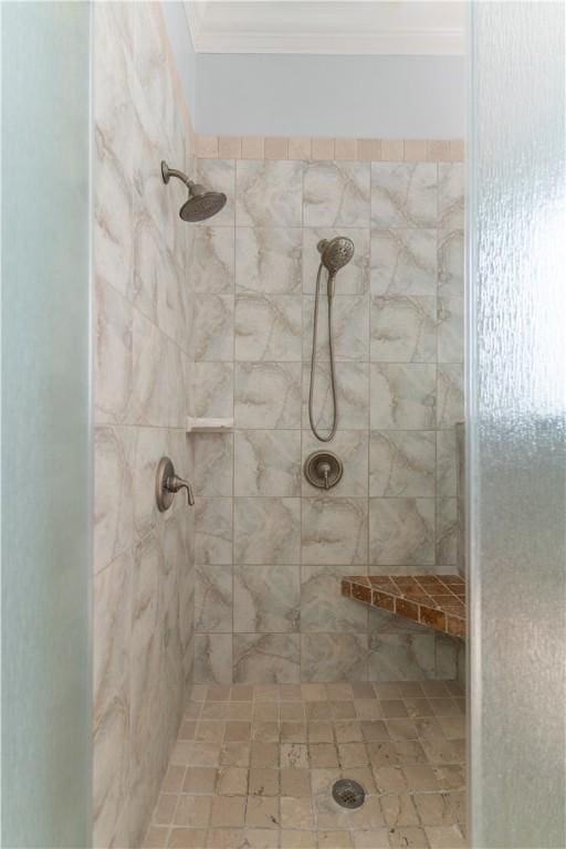 bathroom with tiled shower and ornamental molding