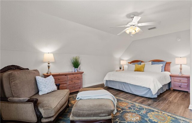 bedroom featuring ceiling fan, lofted ceiling, and dark hardwood / wood-style floors