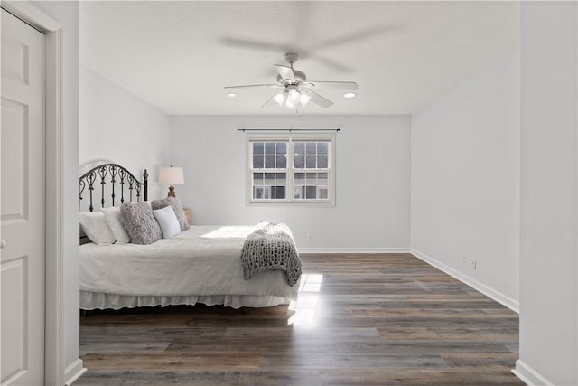 bedroom with ceiling fan and dark hardwood / wood-style flooring