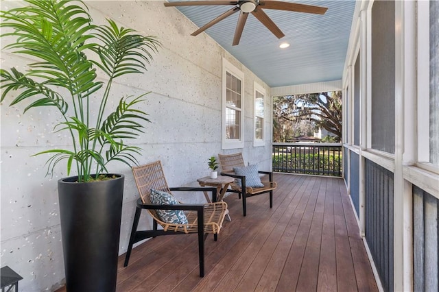 wooden deck featuring ceiling fan