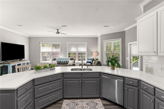 kitchen with a sink, gray cabinets, open floor plan, and dishwasher