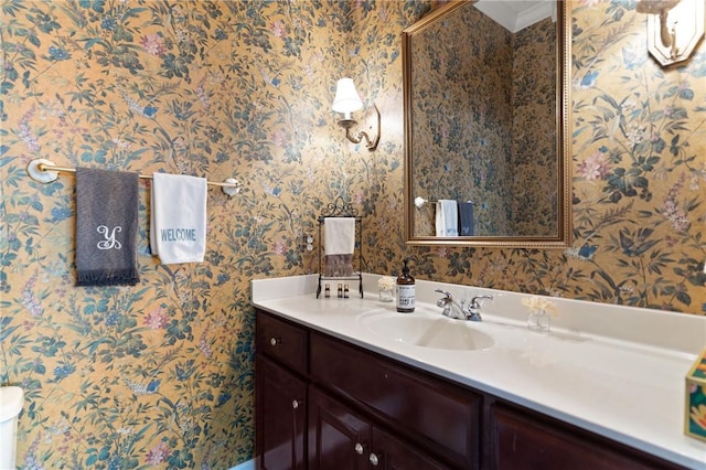bathroom featuring vanity and wallpapered walls