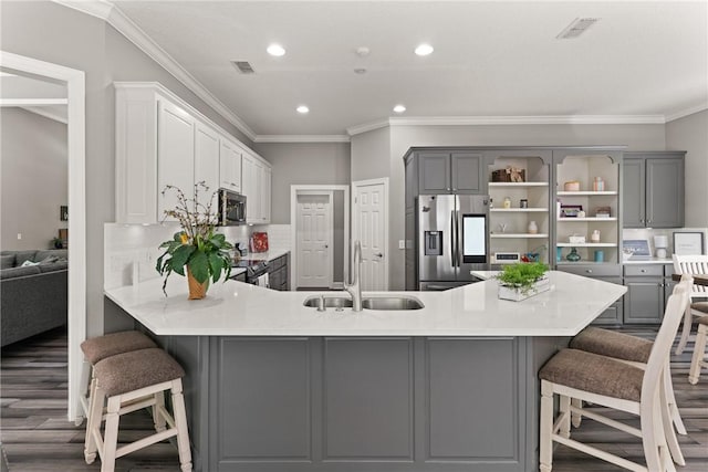 kitchen featuring a sink, appliances with stainless steel finishes, gray cabinetry, and ornamental molding