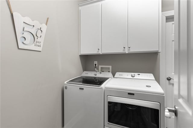 laundry area with washing machine and dryer and cabinet space