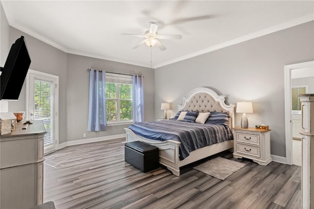 bedroom featuring baseboards, wood finished floors, and multiple windows