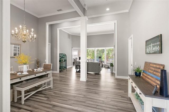 interior space with baseboards, decorative columns, wood finished floors, and visible vents