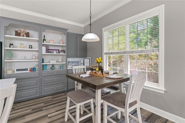 dining room with crown molding, baseboards, and dark wood-style flooring