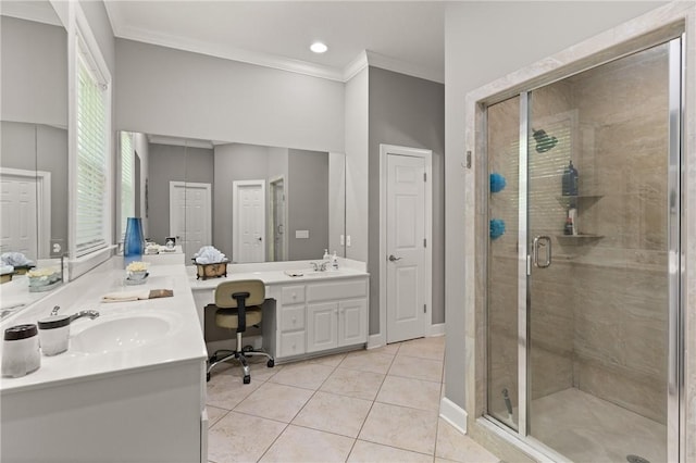 full bath featuring tile patterned flooring, ornamental molding, double vanity, a shower stall, and a sink