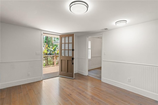315 Pine St, Saint Simons Island, GA 31522 - empty room featuring hardwood / wood-style flooring and a wainscoted wall