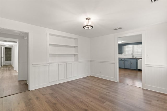 315 Pine St, Saint Simons Island, GA 31522 - unfurnished dining area with built in features, wood finished floors, and wainscoting