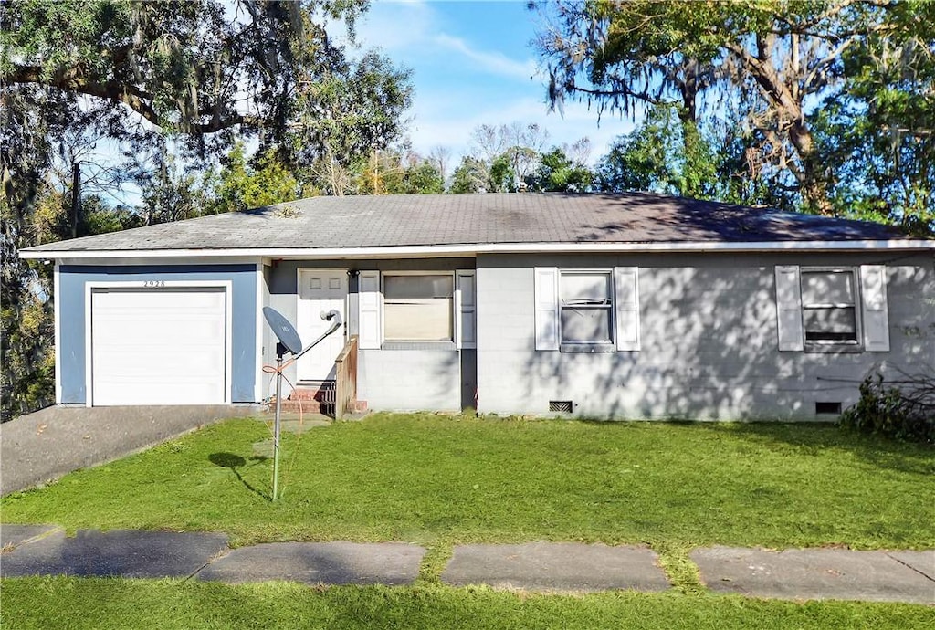 single story home with a garage and a front lawn