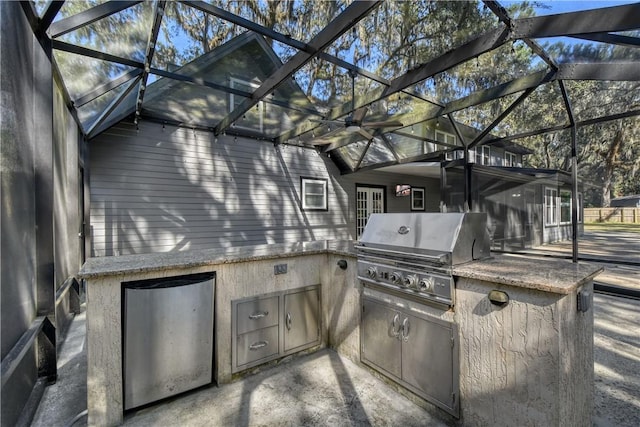 109 Mackay Cir, Brunswick, GA 31525 - view of patio featuring an outdoor kitchen, area for grilling, and glass enclosure