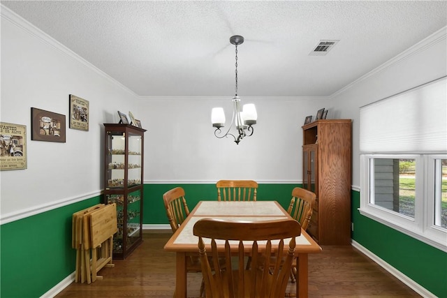 109 Mackay Cir, Brunswick, GA 31525 - dining space with a textured ceiling, ornamental molding, dark wood-type flooring, and a chandelier