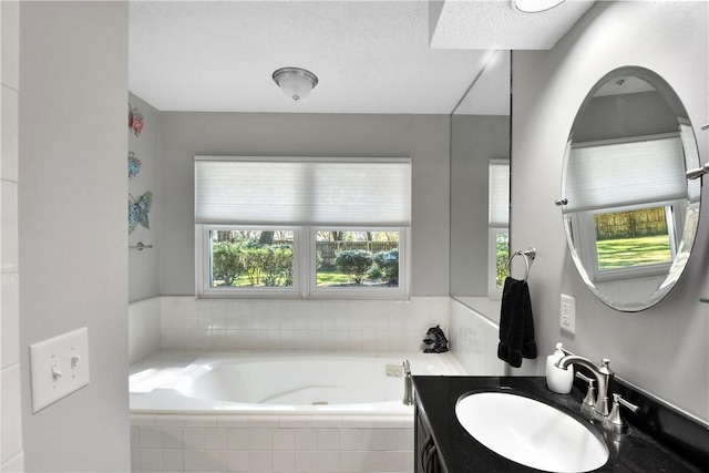 109 Mackay Cir, Brunswick, GA 31525 - bathroom with a textured ceiling, vanity, and tiled tub