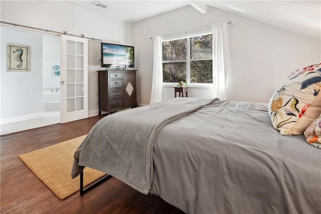 bedroom featuring a barn door, baseboards, visible vents, dark wood finished floors, and vaulted ceiling with beams