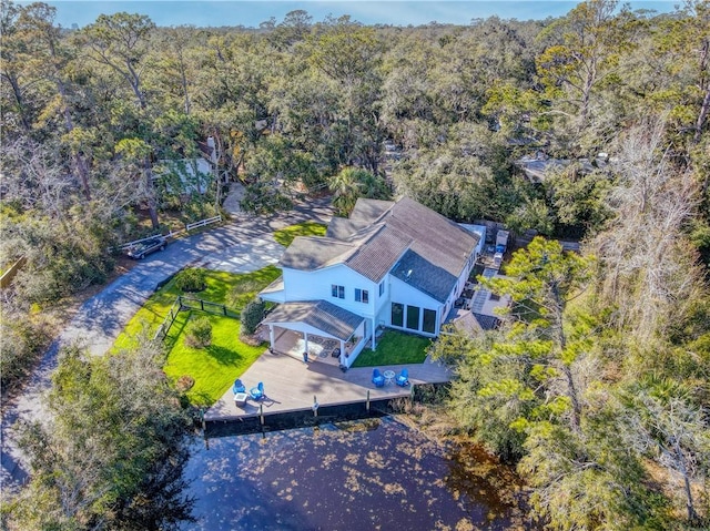 bird's eye view with a wooded view