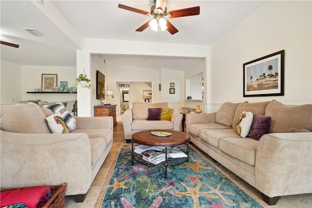 living area with ceiling fan and visible vents